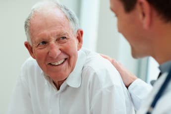 Male doctor discussing with his patient outdoor defibrillators