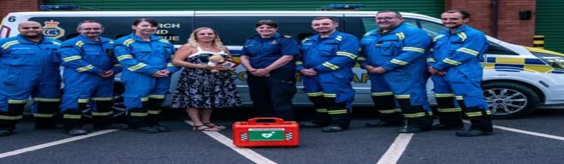 coastguard-team-aed-rescue-donna-survivor-story.jpg (2) UK Coastguard team with AED and cardiac arrest survivor Donna outside rescue vehicle